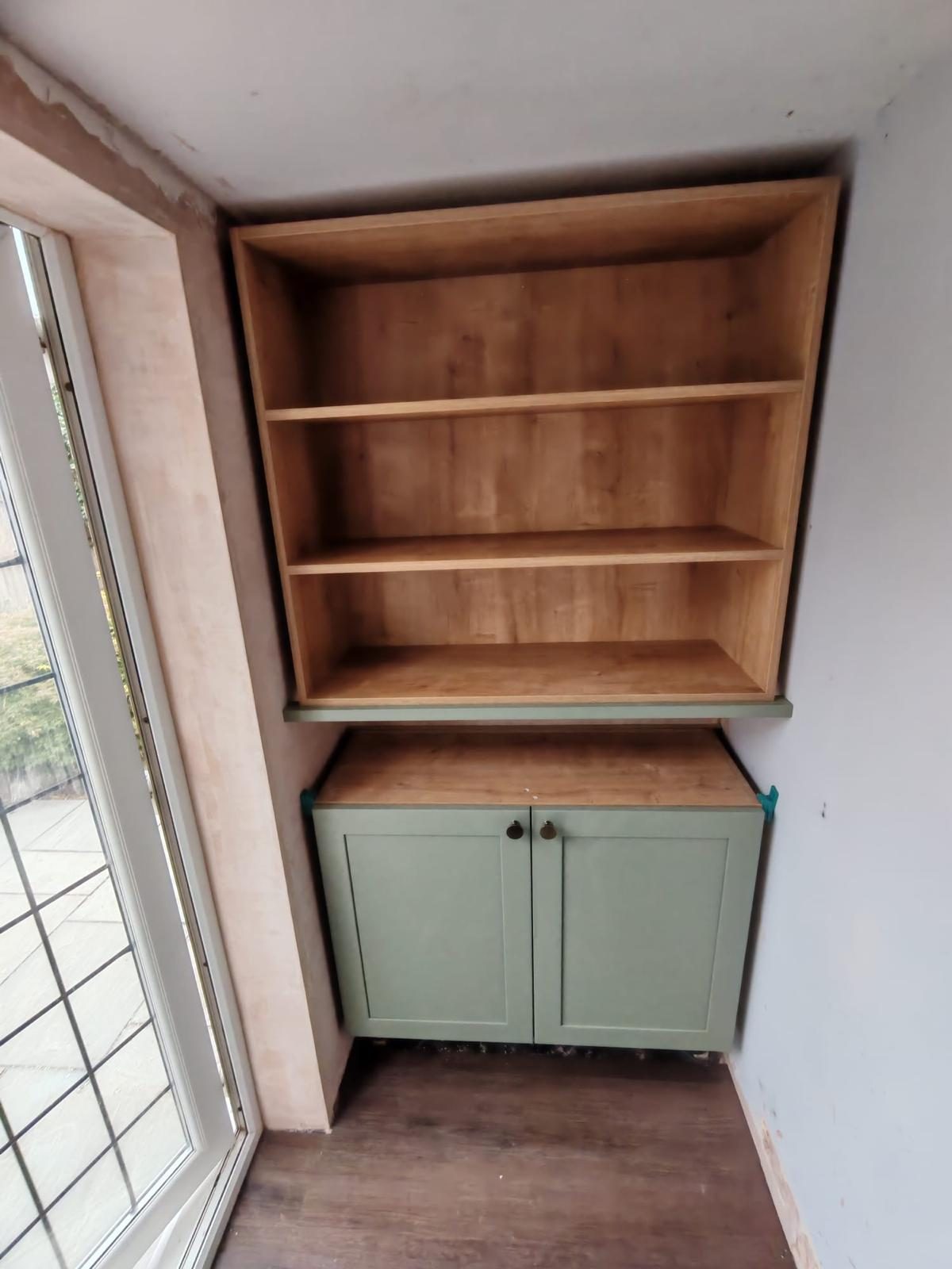 Fitted alcove shelving with sage green shaker cabinet, bespoke carpentry in West Sussex