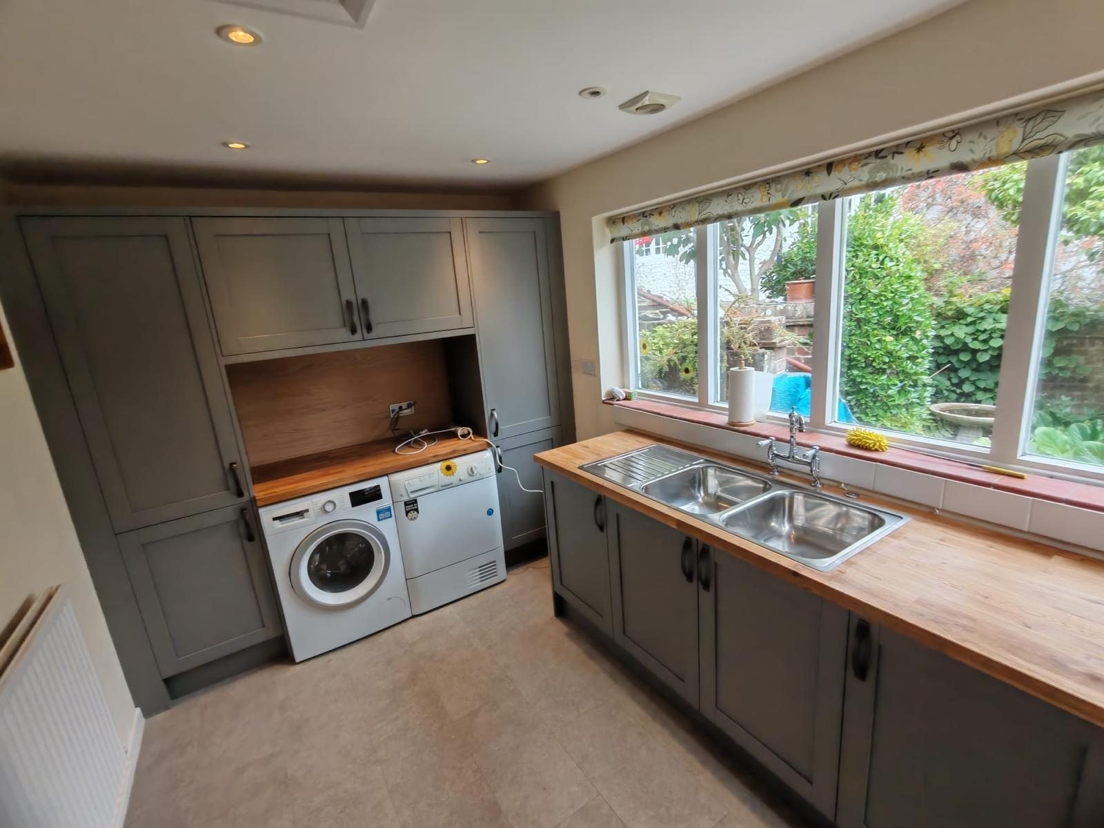Shaker utility room with oak worktop, double sink and appliance housing