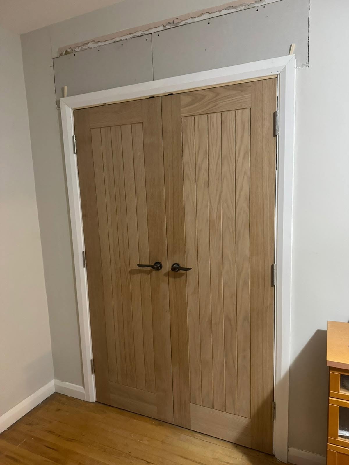 Pair of oak cottage-style double doors fitted in a new white door frame