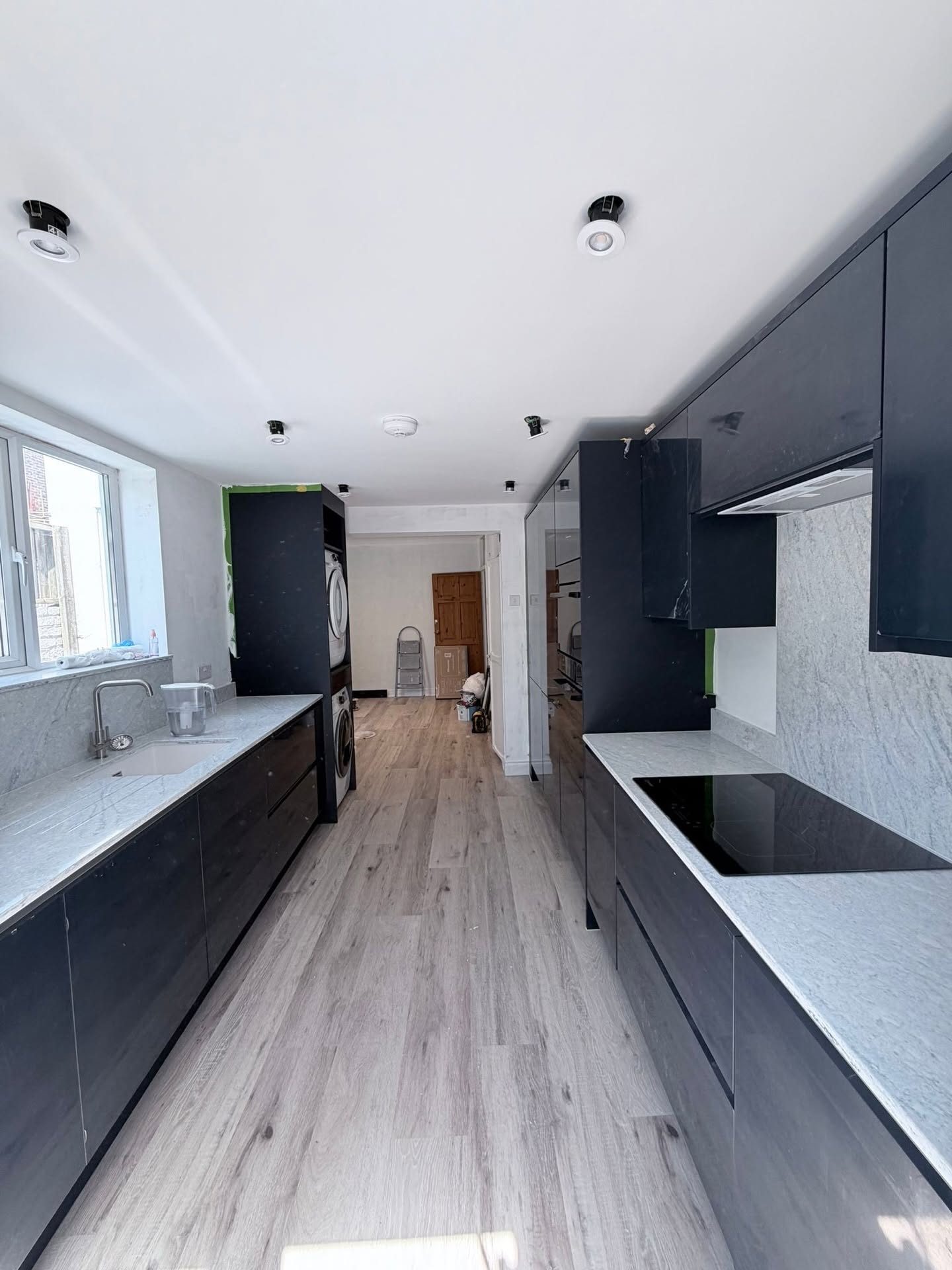 Anthracite gloss galley kitchen with granite worktops fitted in West Sussex