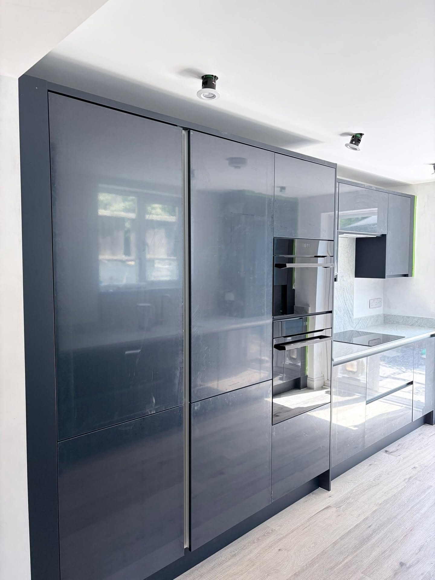 Tall anthracite gloss kitchen units with built-in ovens, kitchen fitting Littlehampton