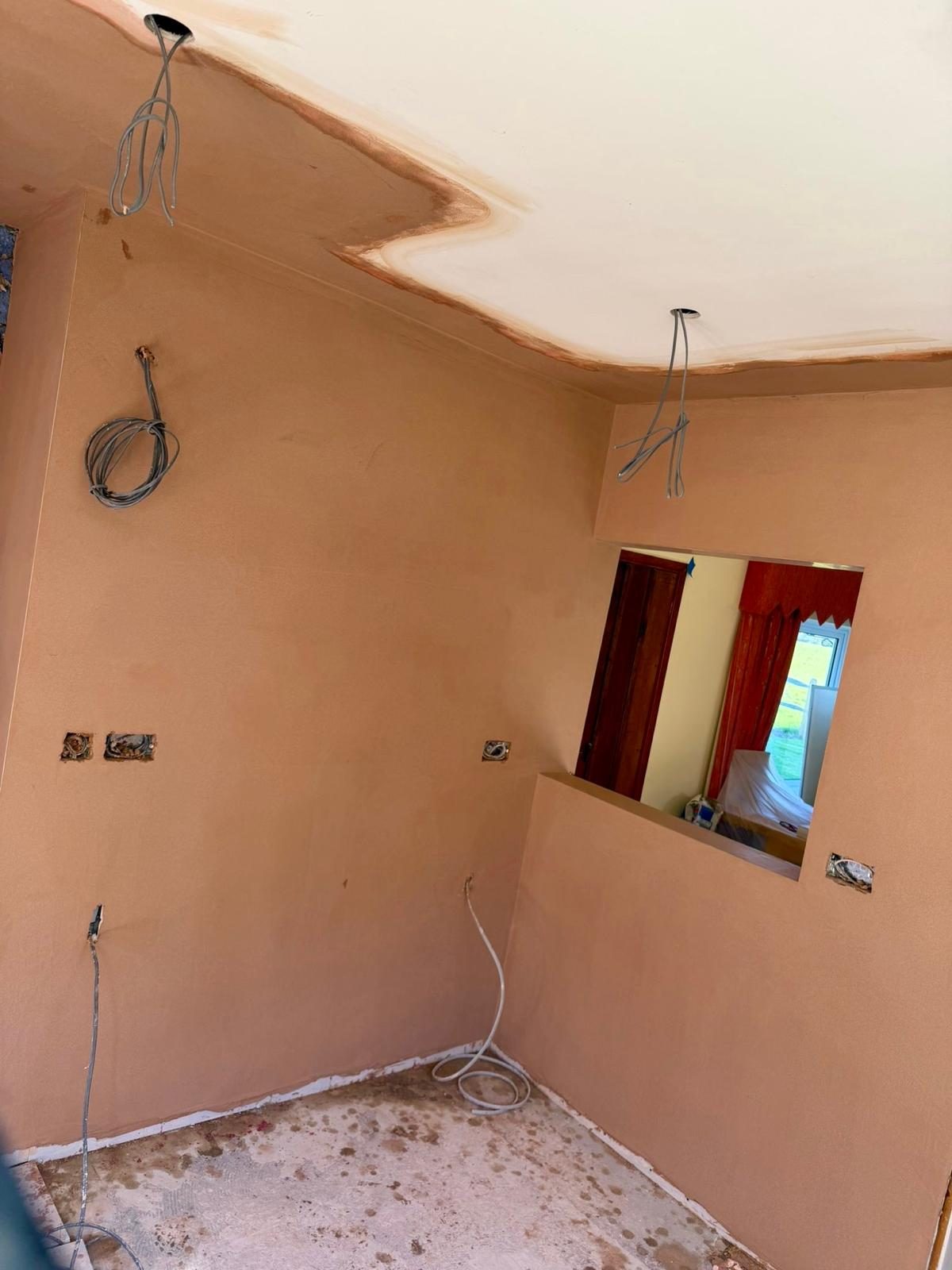 Knock-through with new serving hatch opening, freshly plastered walls