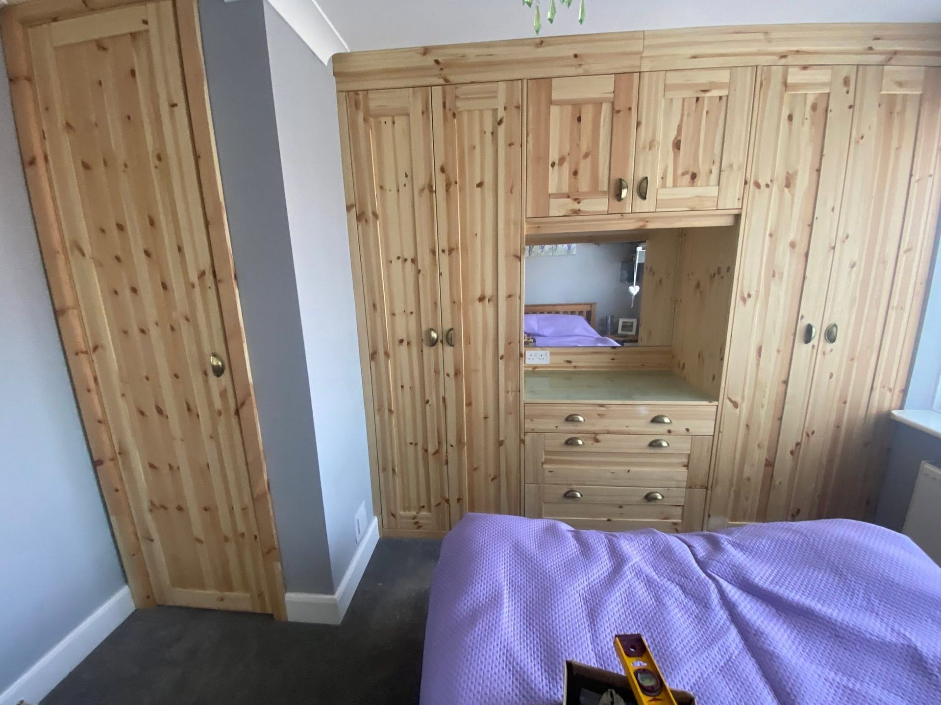 Made-to-measure fitted pine wardrobes with dressing table in a West Sussex bedroom