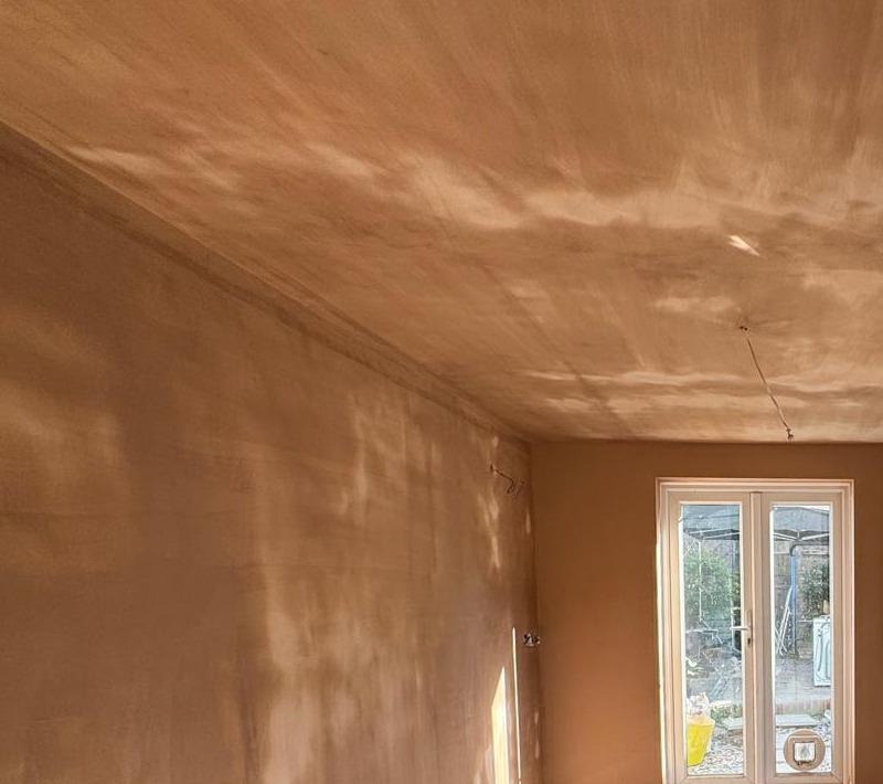 Freshly plastered house extension with French doors opening to the garden in West Sussex
