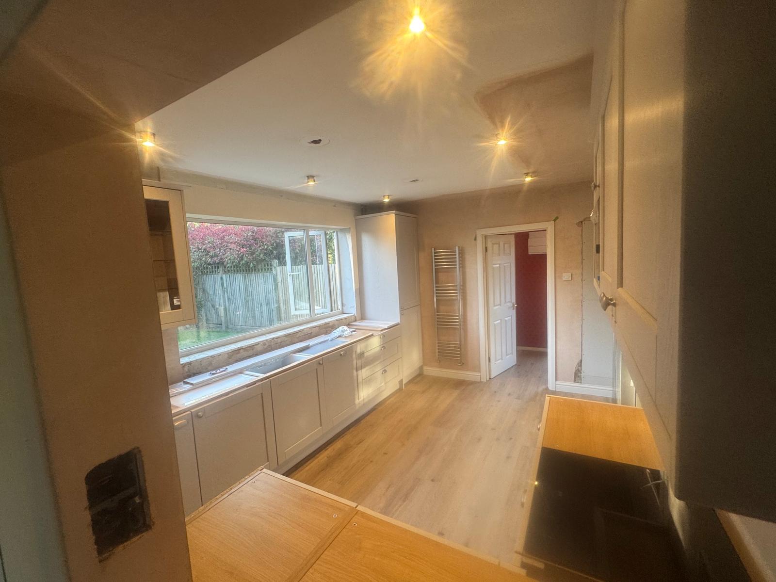 Light grey shaker kitchen being fitted beneath a garden window, kitchen fitting in Littlehampton